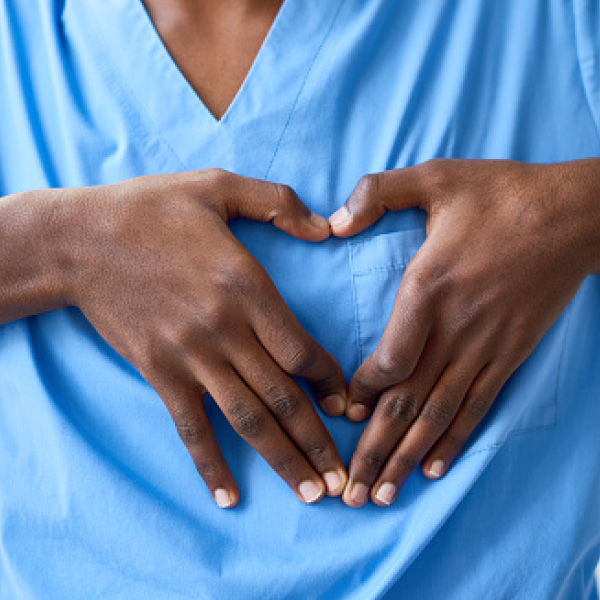 Hands making a heart over chest